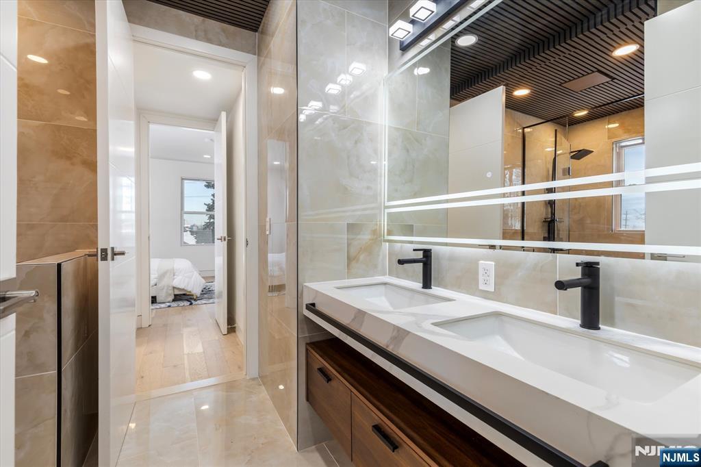 33 Elycroft Parkway Rutherford, NJ 07070 - Photo 27 of 46 a bathroom with a sink a mirror and a shower