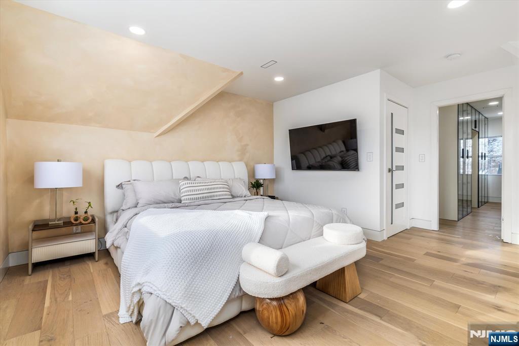 33 Elycroft Parkway Rutherford, NJ 07070 - Photo 32 of 46 a bedroom with a bed and a flat screen tv