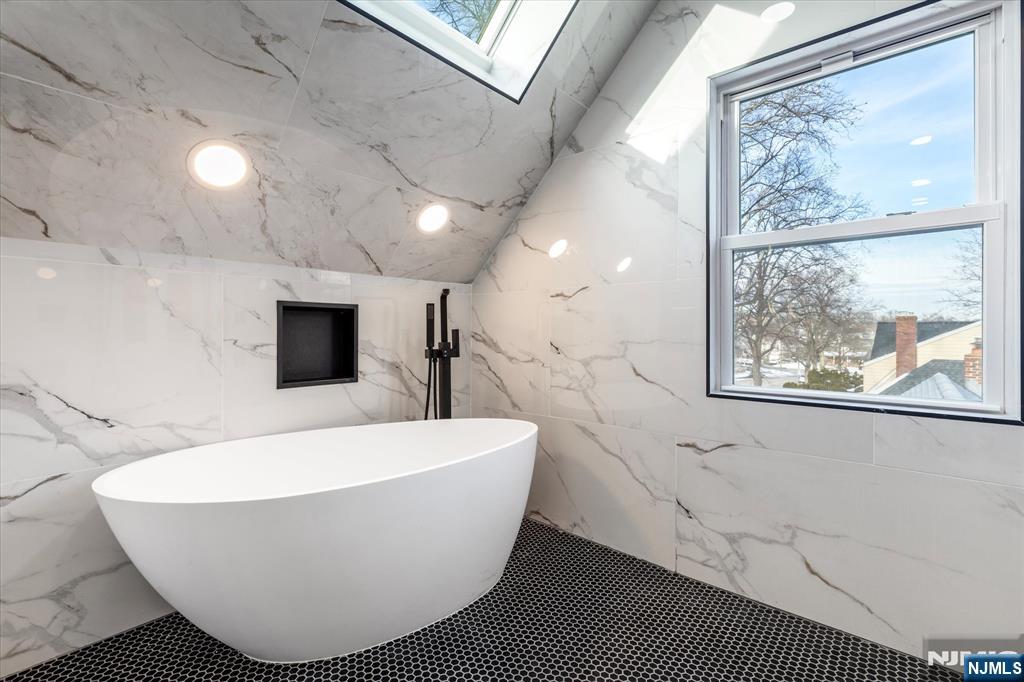 33 Elycroft Parkway Rutherford, NJ 07070 - Photo 35 of 46 a white bath tub sitting in a bathroom