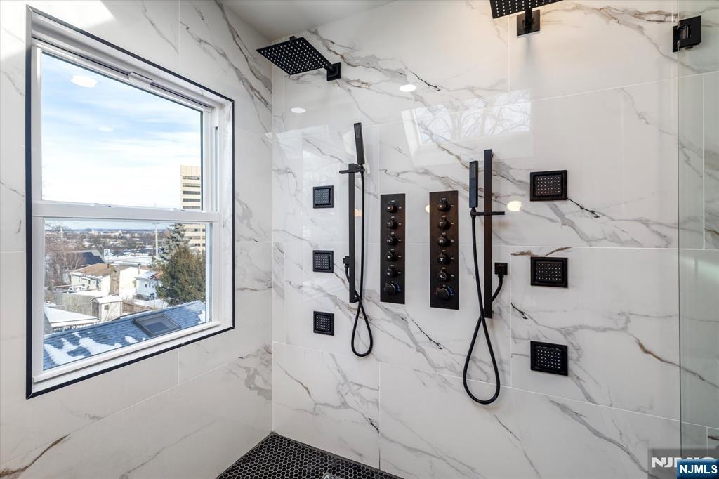 33 Elycroft Parkway Rutherford, NJ 07070 - Photo 36 of 46 a bathroom with a tub sink and mirror