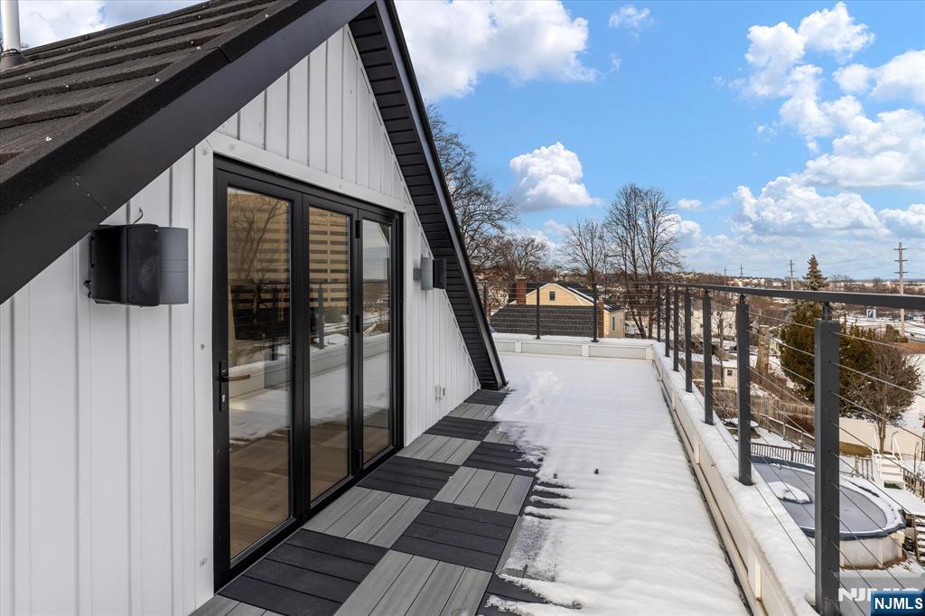33 Elycroft Parkway Rutherford, NJ 07070 - Photo 37 of 46 a view of a balcony with wooden floor and iron stairs
