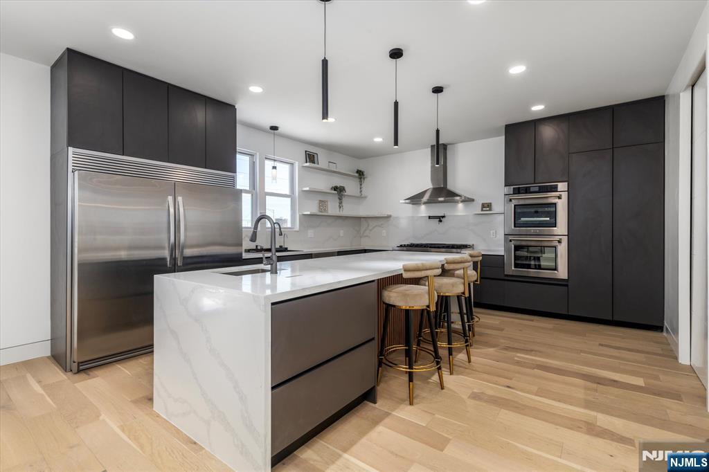 33 Elycroft Parkway Rutherford, NJ 07070 - Photo 9 of 46 a kitchen with kitchen island stainless steel appliances a sink stove and refrigerator