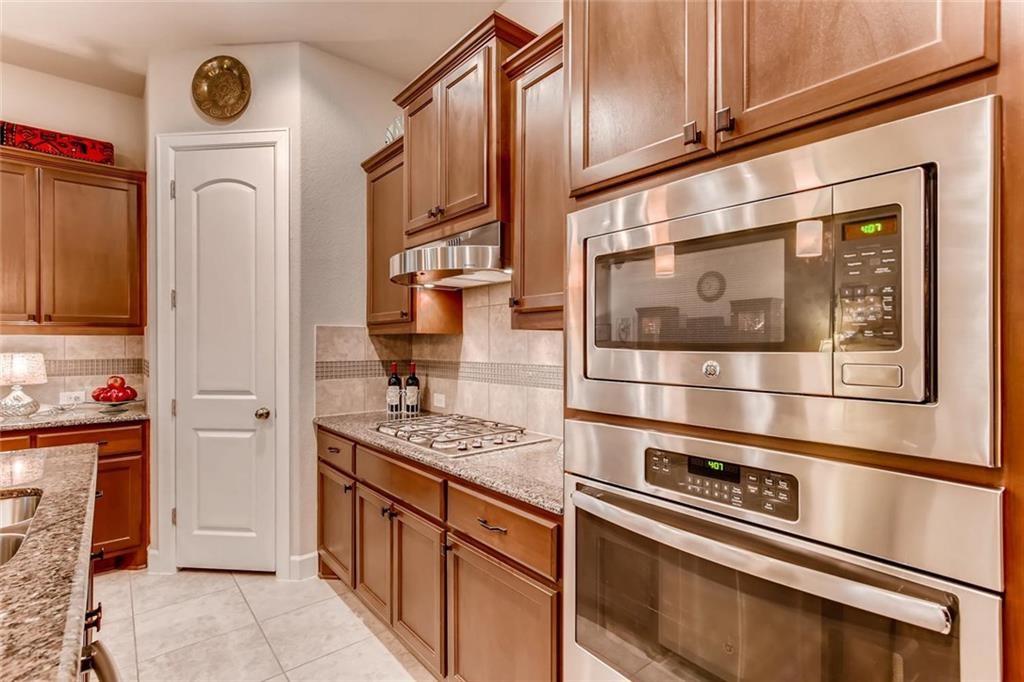 3124 Pablo Way Round Rock, TX 78665 - Photo 11 of 25 a kitchen with stainless steel appliances granite countertop a refrigerator and a stove