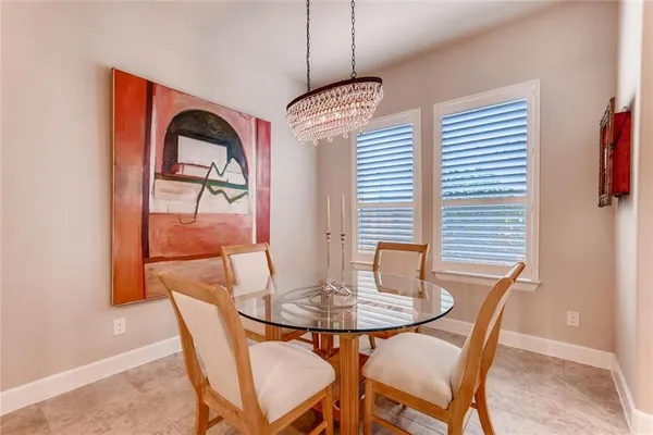 a kitchen with stainless steel appliances granite countertop a kitchen island a stove a table and chairs