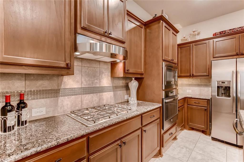 3124 Pablo Way Round Rock, TX 78665 - Photo 8 of 25 a kitchen with stainless steel appliances granite countertop a sink stove and refrigerator
