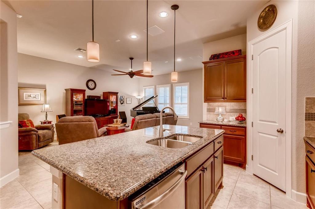 3124 Pablo Way Round Rock, TX 78665 - Photo 10 of 25 a kitchen with stainless steel appliances granite countertop a sink a stove and a wooden floor