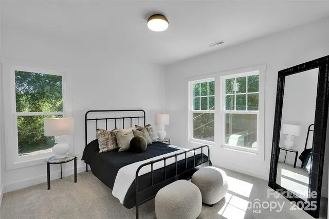 a bedroom with bed and wooden floor