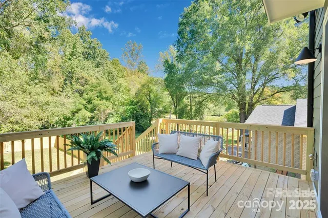 a view of balcony with wooden floor and outdoor seating