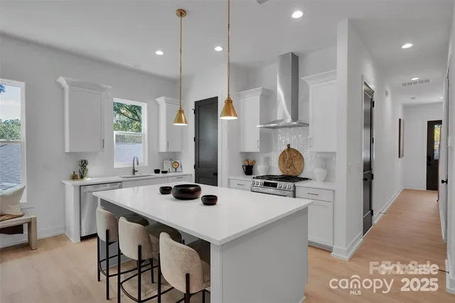 a kitchen with stainless steel appliances a sink stove and refrigerator