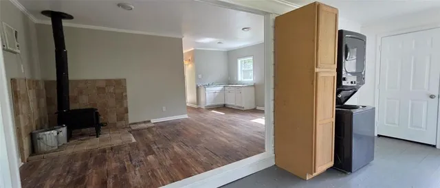 a view of a room with wooden floor and a window