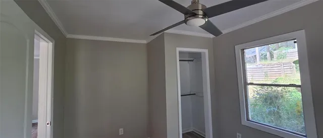 a view of a livingroom with a ceiling fan and window