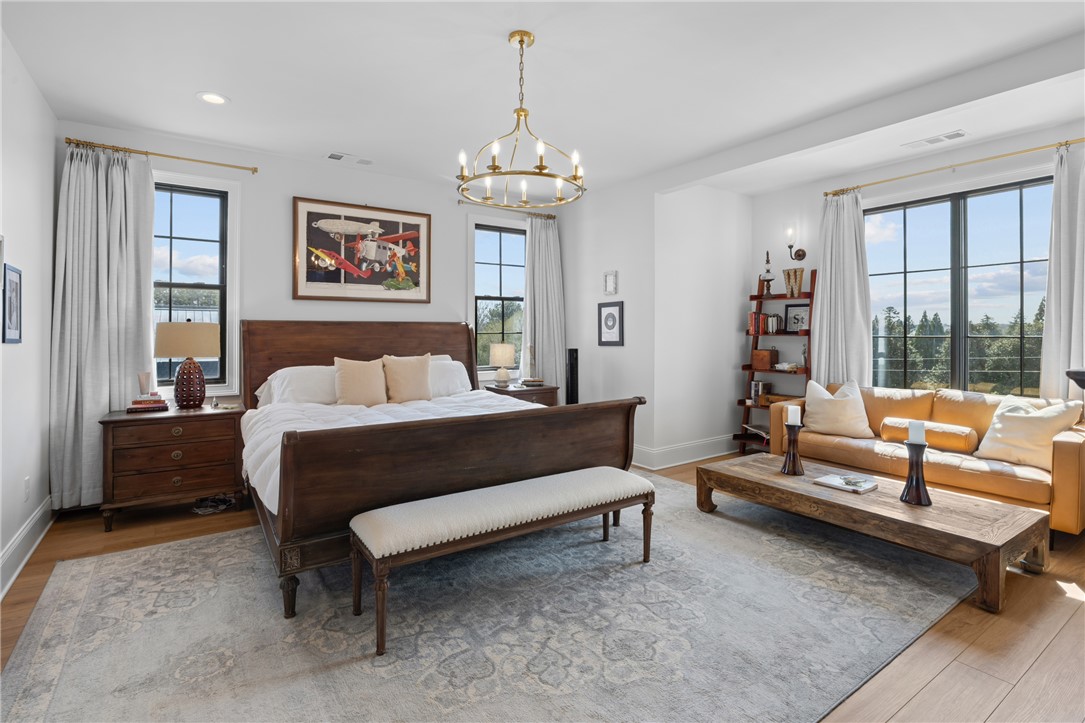 677 Lightwood Road Hartwell, GA 30643 - Photo 21 of 42 This primary bedroom suite features hardwood floors and large windows, creating a bright and airy retreat.