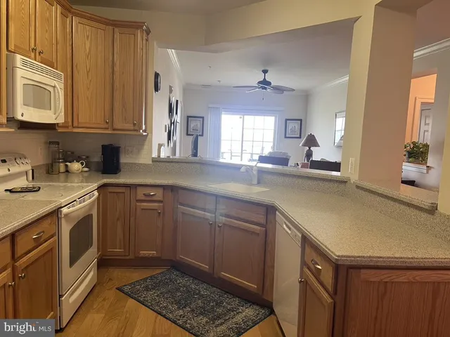a kitchen with a sink cabinets and window