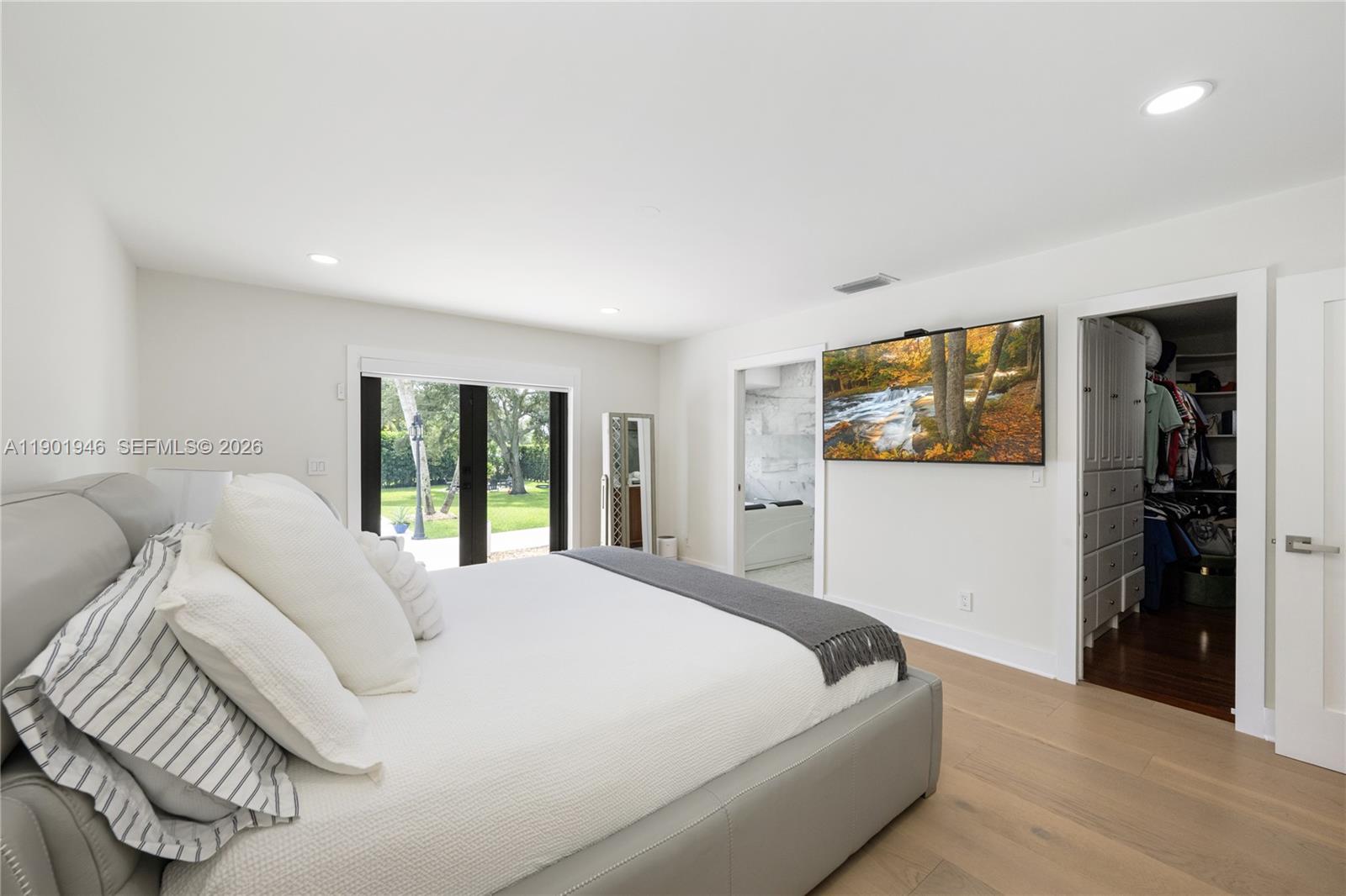 15110 North Saxon Circle Southwest Ranches, FL 33331 - Photo 11 of 45 a bedroom with a large bed and a large window