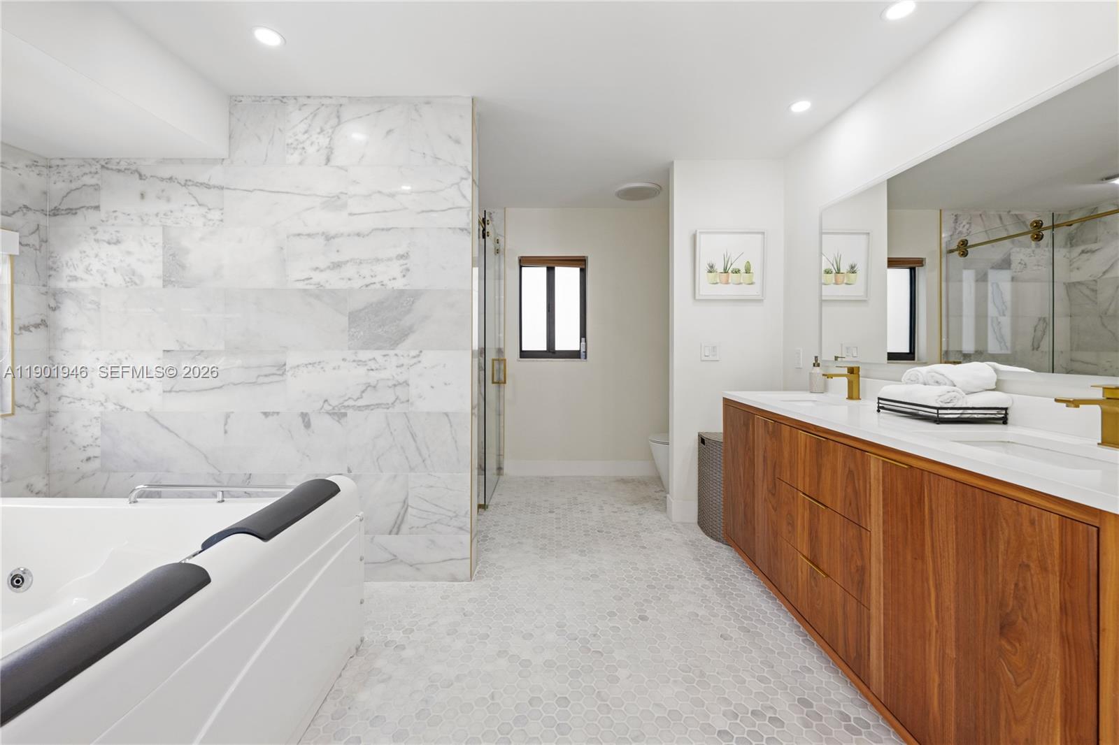 15110 North Saxon Circle Southwest Ranches, FL 33331 - Photo 14 of 45 a bathroom with a tub sink and mirror