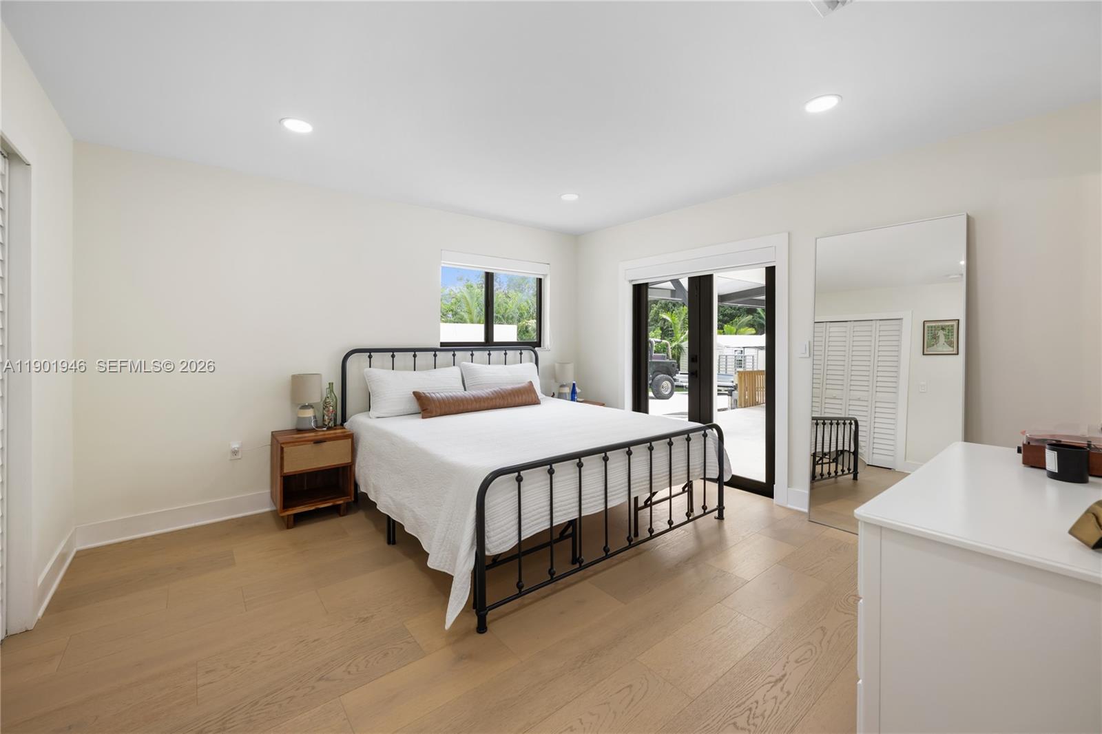 15110 North Saxon Circle Southwest Ranches, FL 33331 - Photo 16 of 45 a bedroom with a bed a table and painting