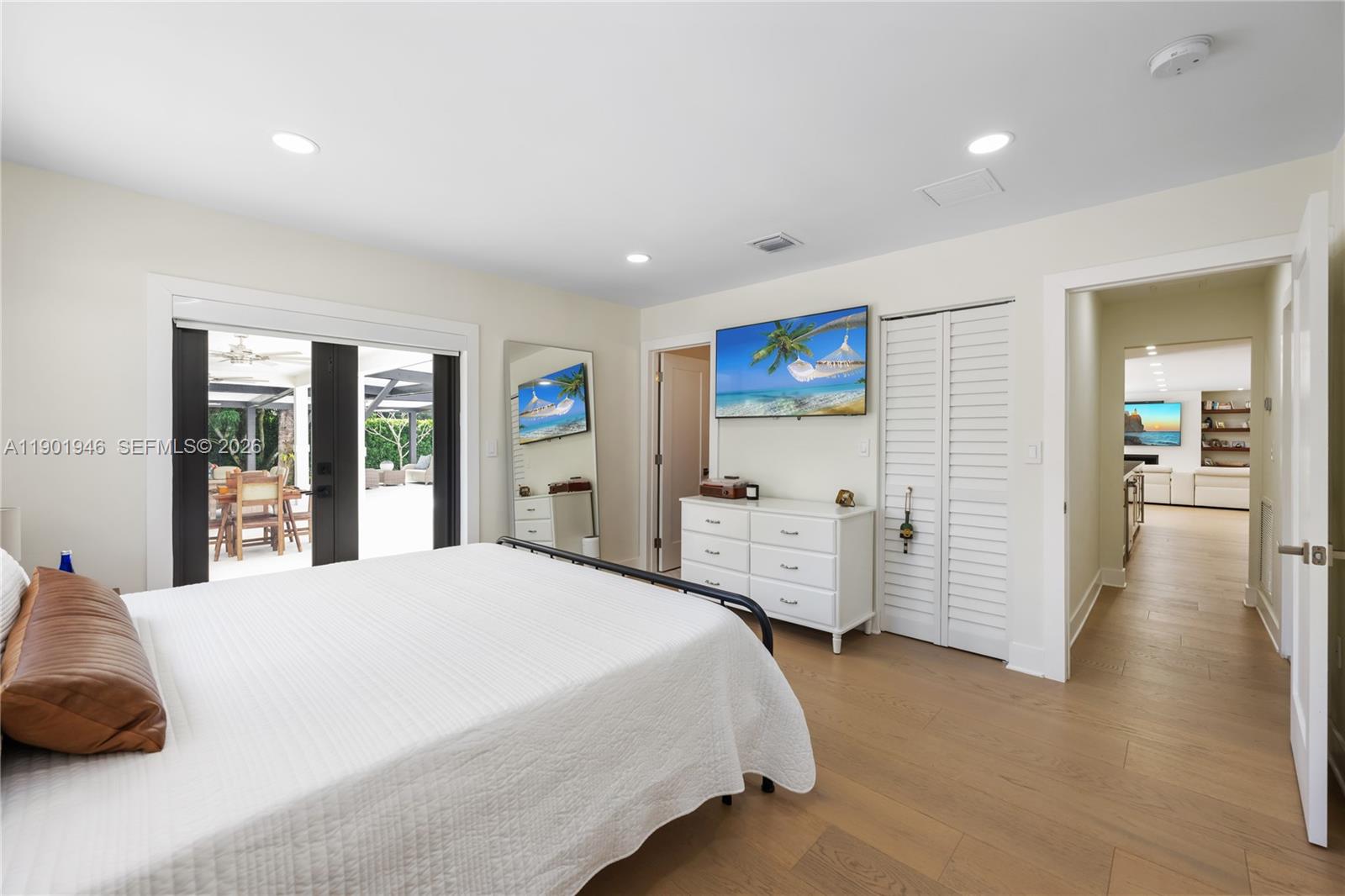 15110 North Saxon Circle Southwest Ranches, FL 33331 - Photo 17 of 45 a spacious bedroom with a bed and wooden floor