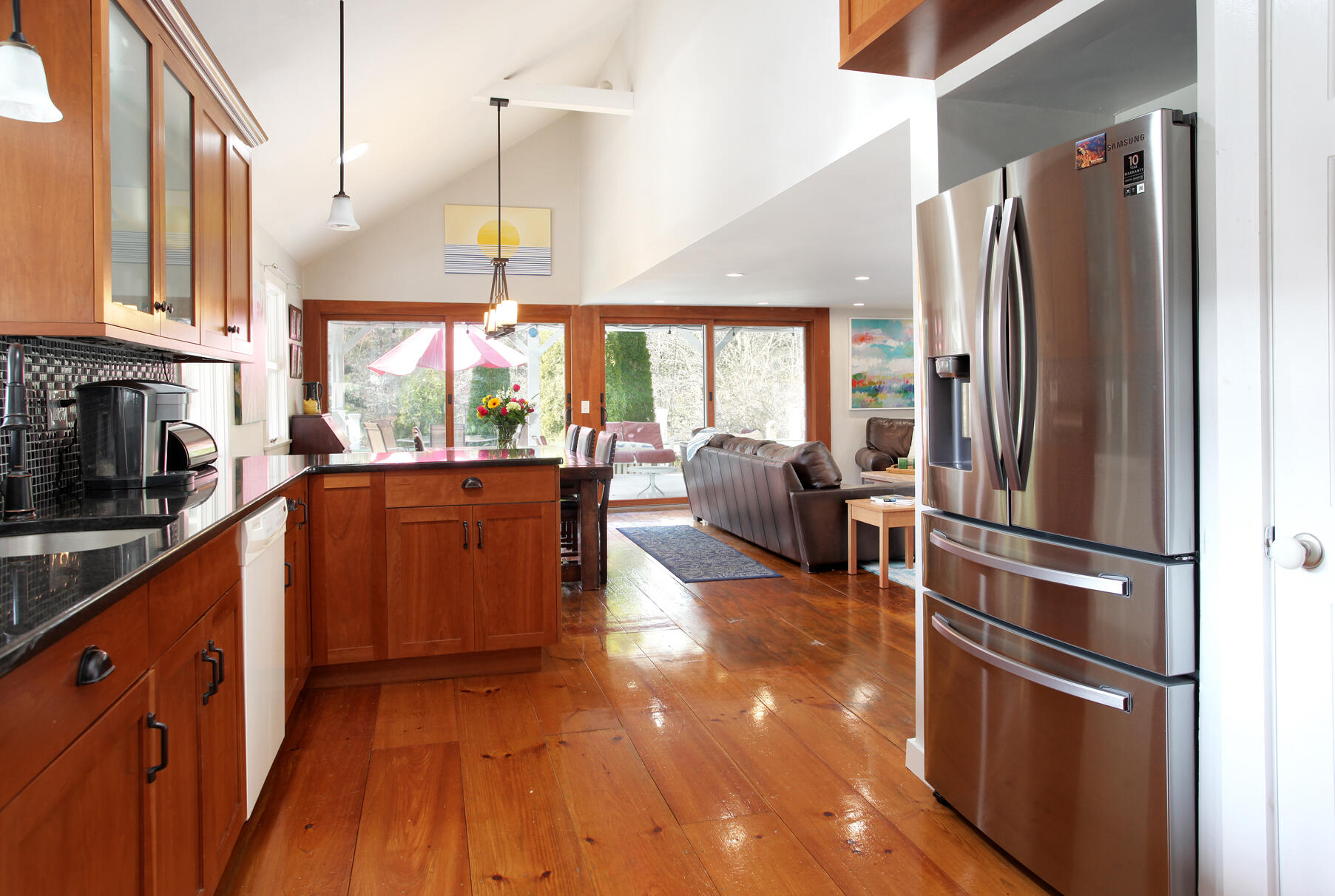 21 5 Corners Road Centerville, MA 02632 - Photo 15 of 38 a kitchen with kitchen island wooden floor center island and stainless steel appliances