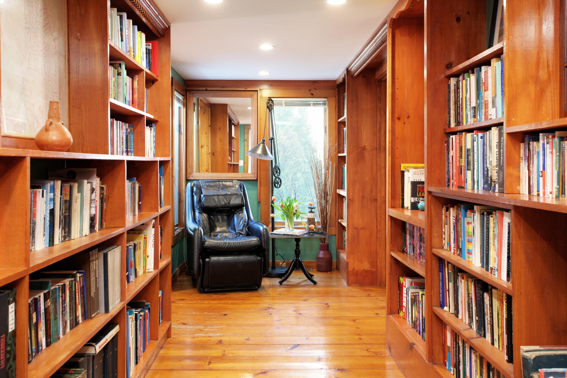 21 5 Corners Road Centerville, MA 02632 - Photo 16 of 38 a living room with furniture lots of books and a book shelf