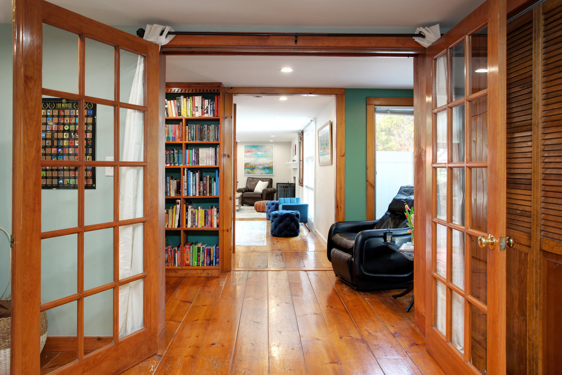 21 5 Corners Road Centerville, MA 02632 - Photo 18 of 38 a living room with furniture a rug and a book shelf