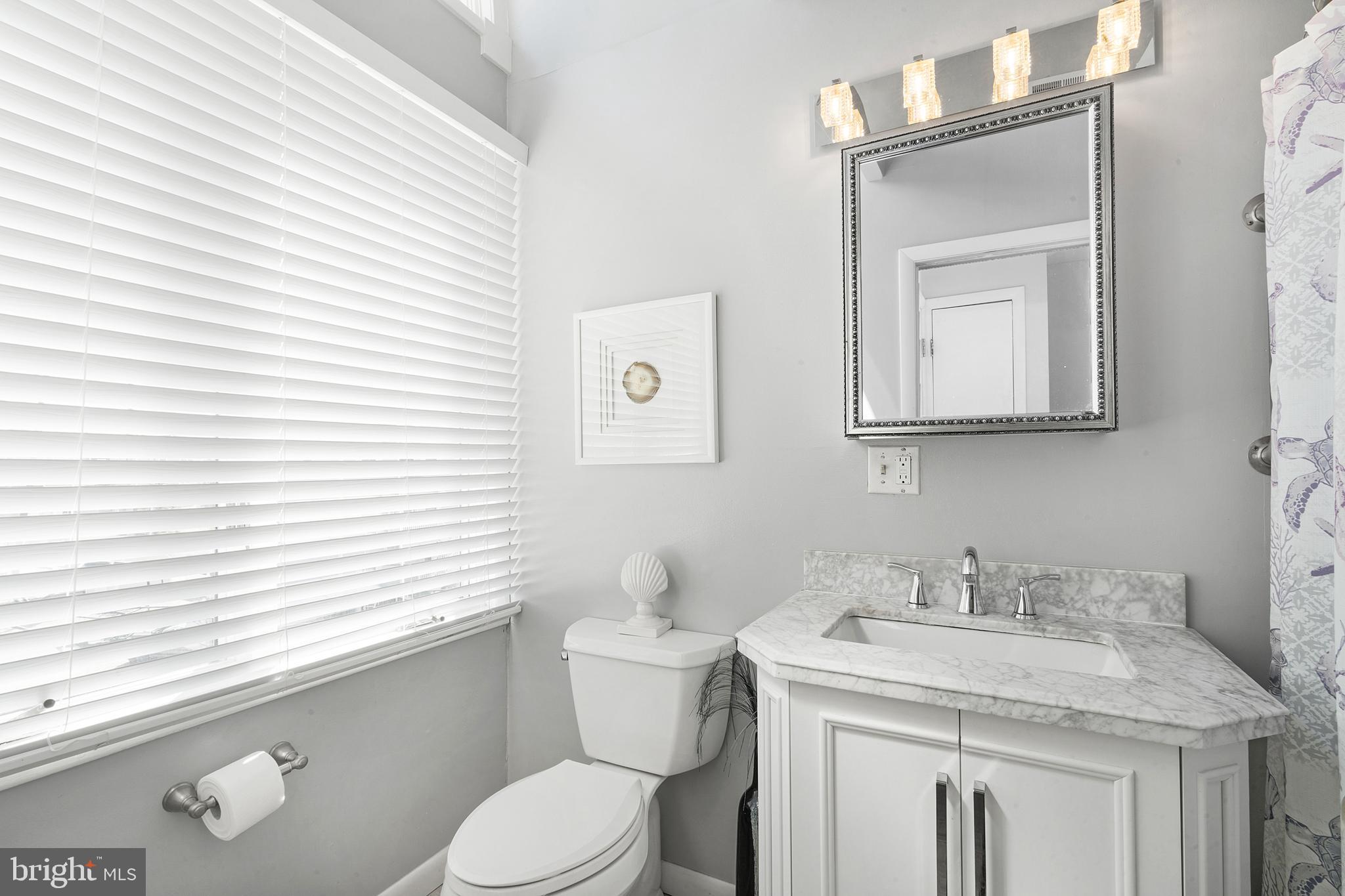 1709 Highway 35, Unit 9 Seaside Heights, NJ 08751 - Photo 17 of 28 a bathroom with a granite countertop toilet sink and mirror