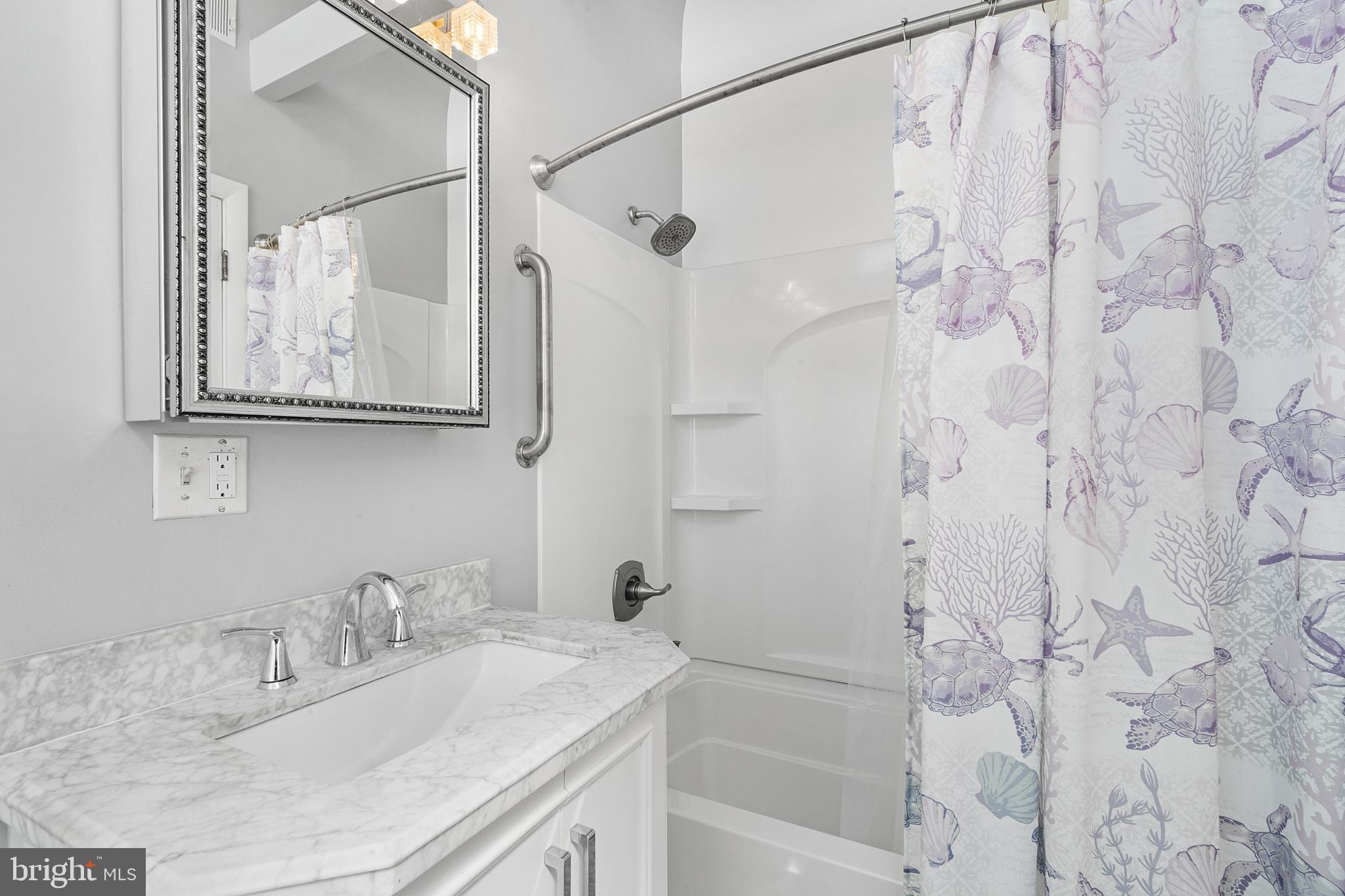 1709 Highway 35, Unit 9 Seaside Heights, NJ 08751 - Photo 18 of 28 a bathroom with a granite countertop sink a mirror a shower and a bathtub