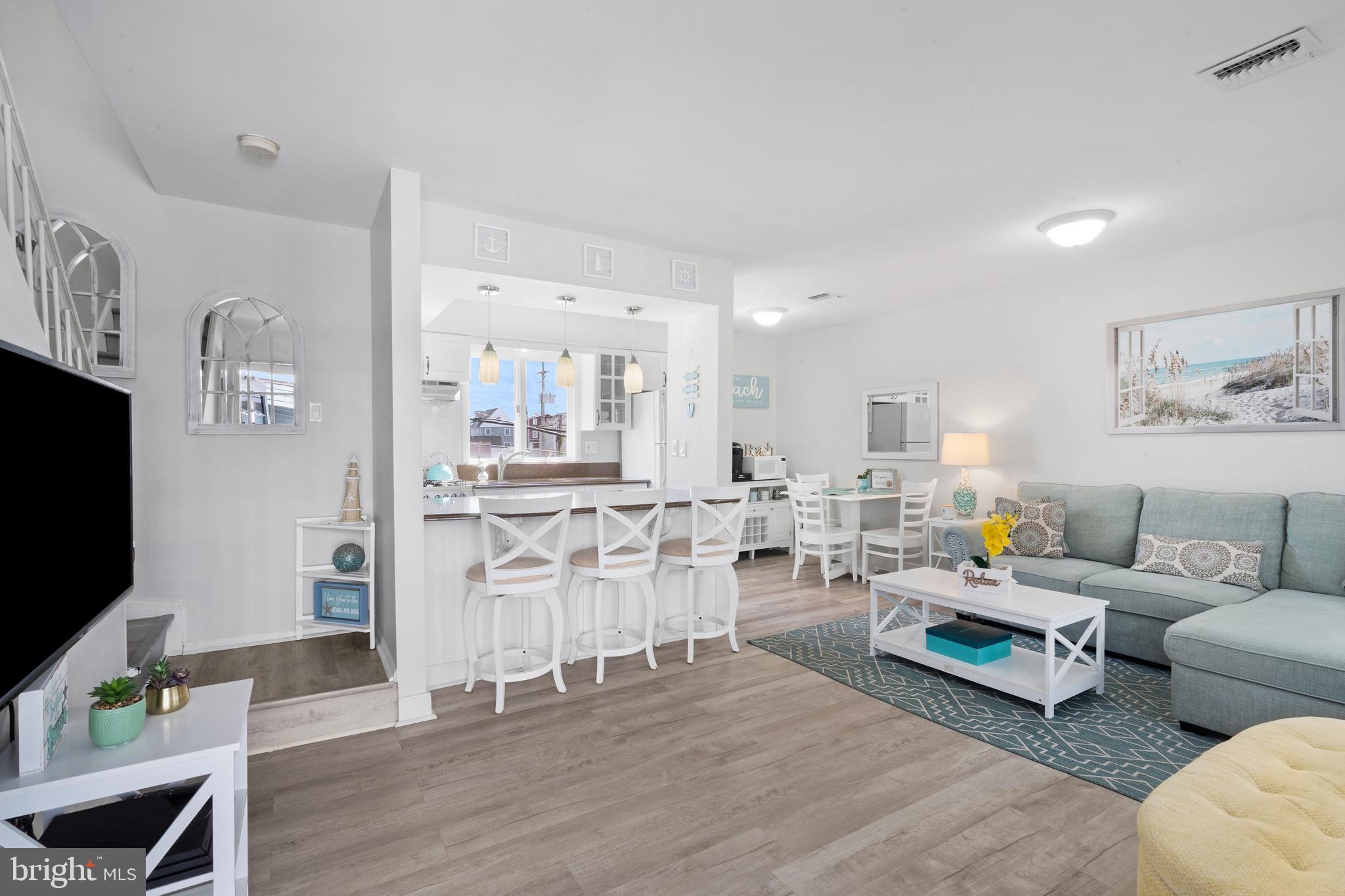 1709 Highway 35, Unit 9 Seaside Heights, NJ 08751 - Photo 2 of 28 a living room with furniture a flat screen tv and kitchen view
