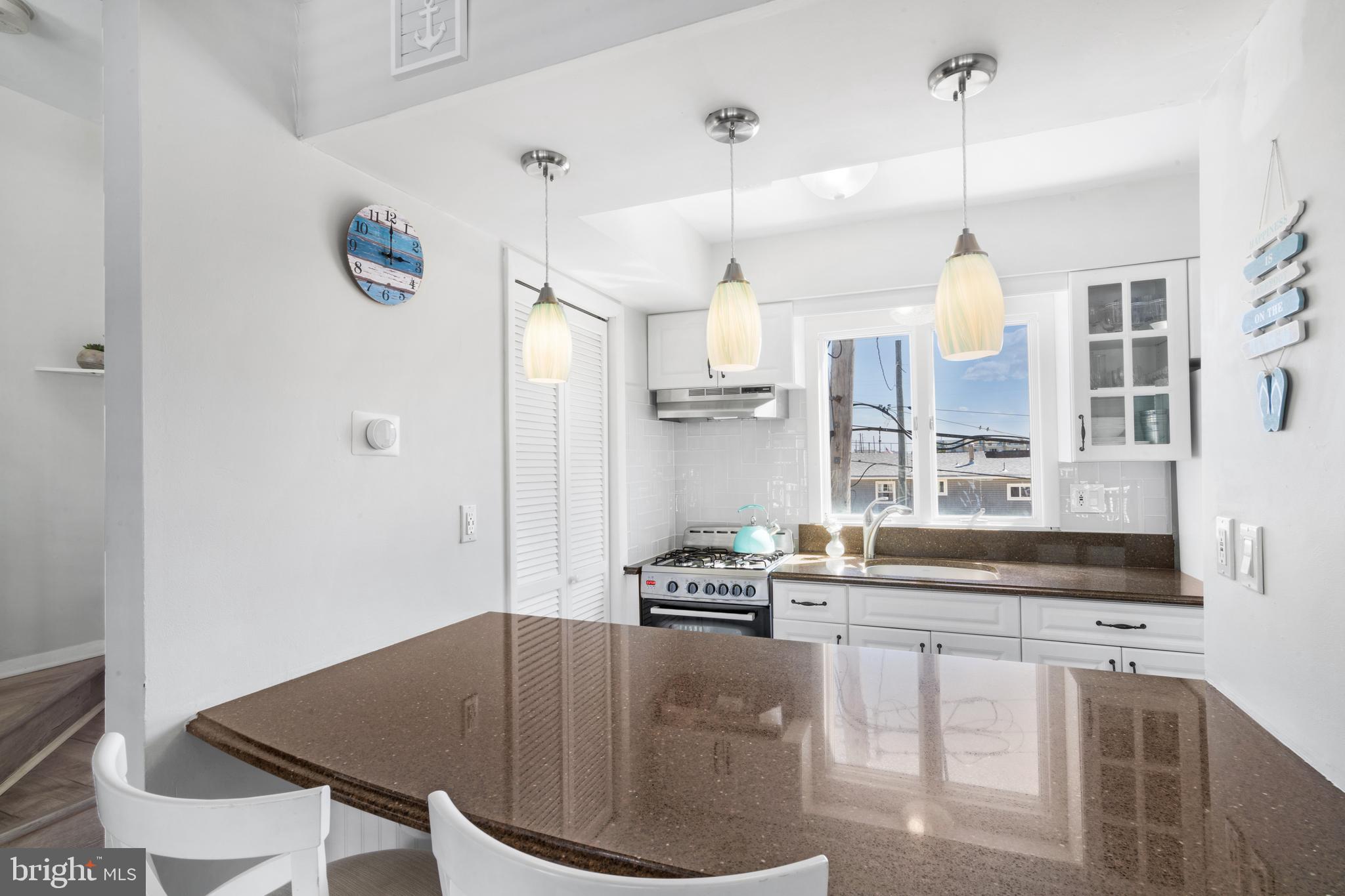 1709 Highway 35, Unit 9 Seaside Heights, NJ 08751 - Photo 5 of 28 a kitchen with stainless steel appliances granite countertop a sink a stove and a refrigerator