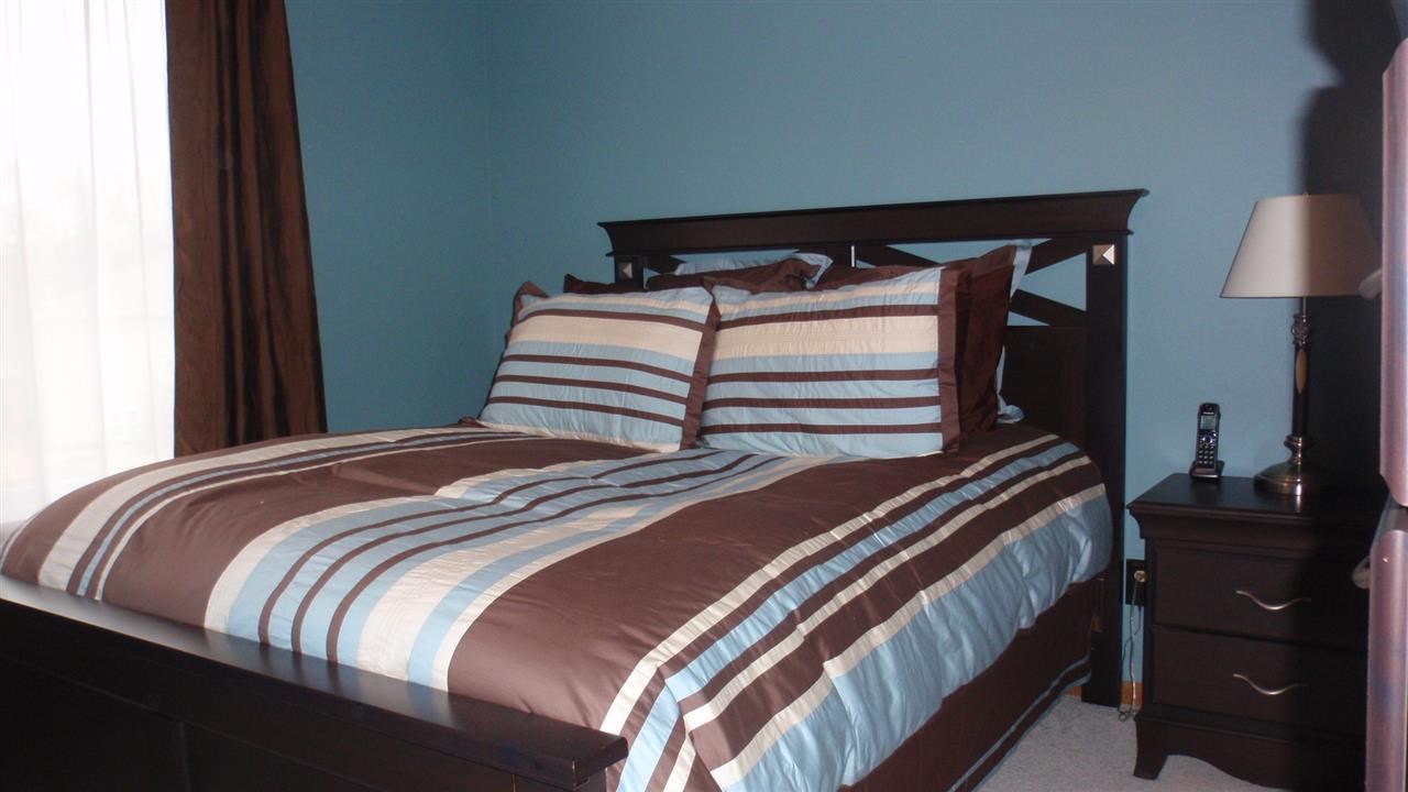 11085 Chicory Ridge Way Roscoe, IL 61073 - Photo 6 of 25 a bedroom with a bed and a lamp on dresser