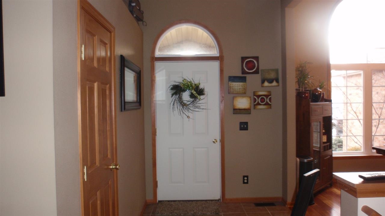 11085 Chicory Ridge Way Roscoe, IL 61073 - Photo 9 of 25 a view of a hallway with wooden floor and a livingroom
