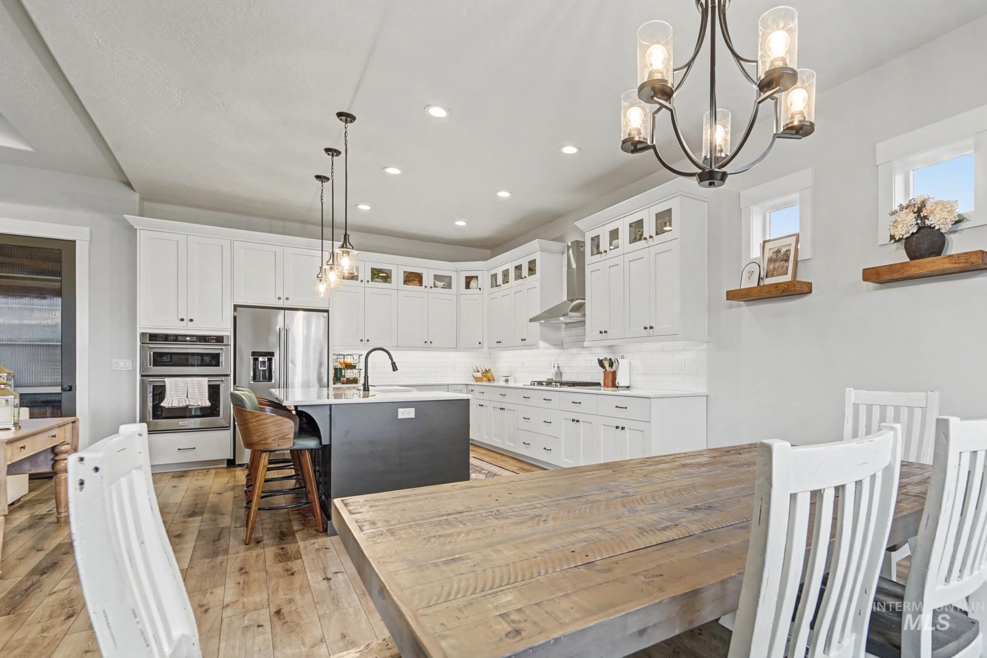 18357 North Burnt Car Way Boise, ID 83714 - Photo 10 of 48 Dining room with light wood-type flooring and hanging lights