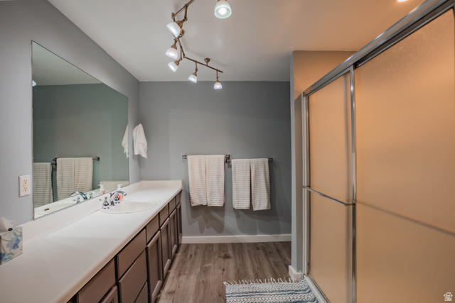 980 Cactus Circle St. George, UT 84790 - Photo 32 of 77 Full bathroom with vanity, a shower stall, and light wood-style floors