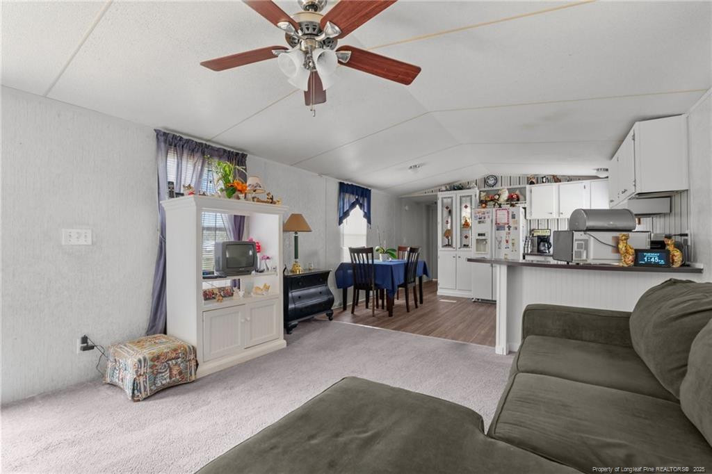 5236-5240 Maxwell Road Stedman, NC 28391 - Photo 15 of 50 a living room with furniture and a dining table with kitchen view