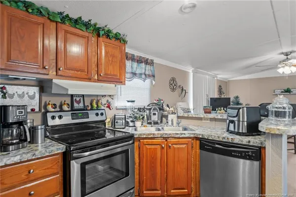 a kitchen with stainless steel appliances granite countertop a stove and a sink