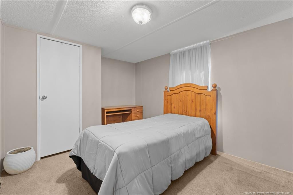 5236-5240 Maxwell Road Stedman, NC 28391 - Photo 28 of 50 a bedroom with a bed and a window