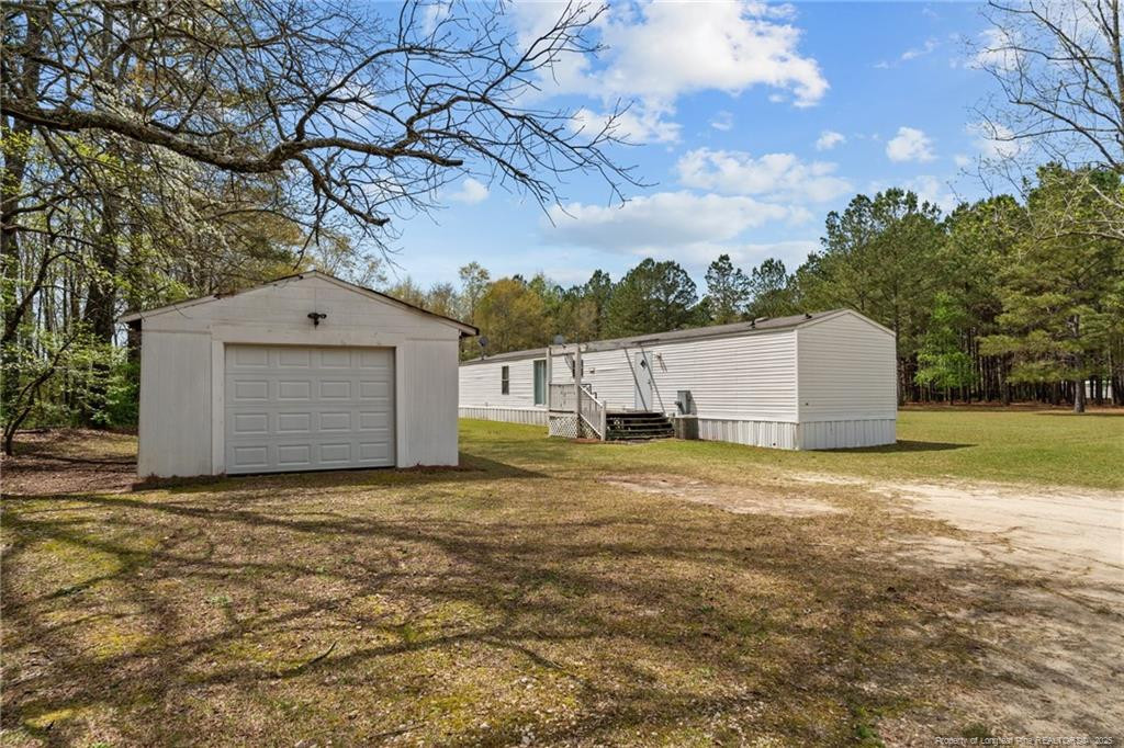 5236-5240 Maxwell Road Stedman, NC 28391 - Photo 39 of 50 a view of a large house with a yard and garage