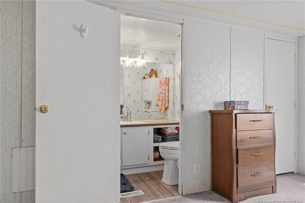 5236-5240 Maxwell Road Stedman, NC 28391 - Photo 4 of 50 a view of a bathroom with a sink and mirror