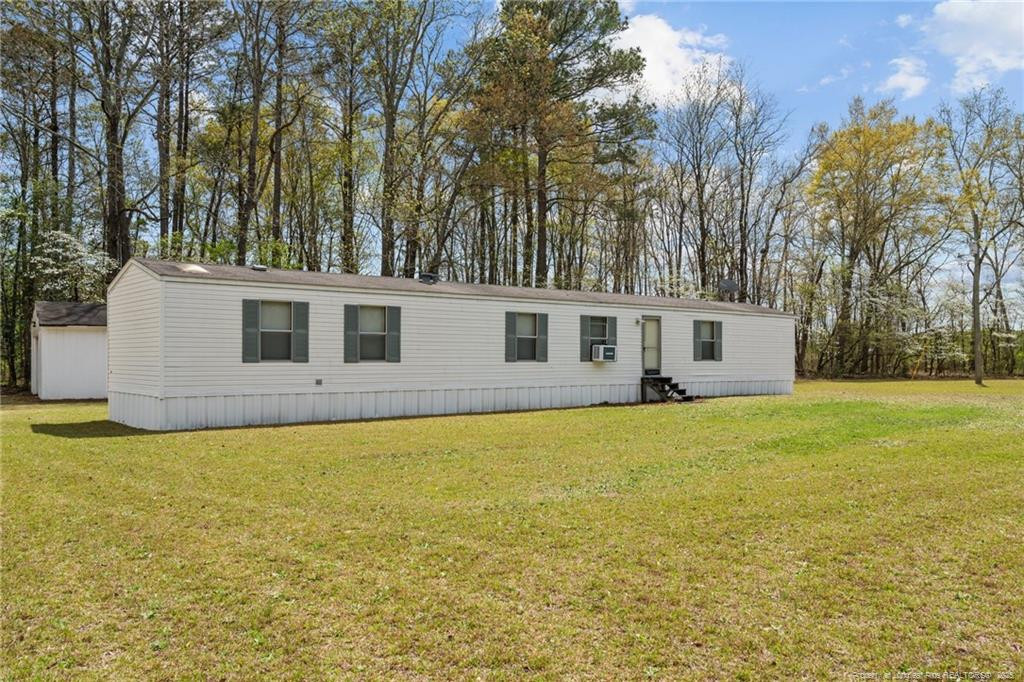 5236-5240 Maxwell Road Stedman, NC 28391 - Photo 45 of 50 a front view of house with yard and trees in the background