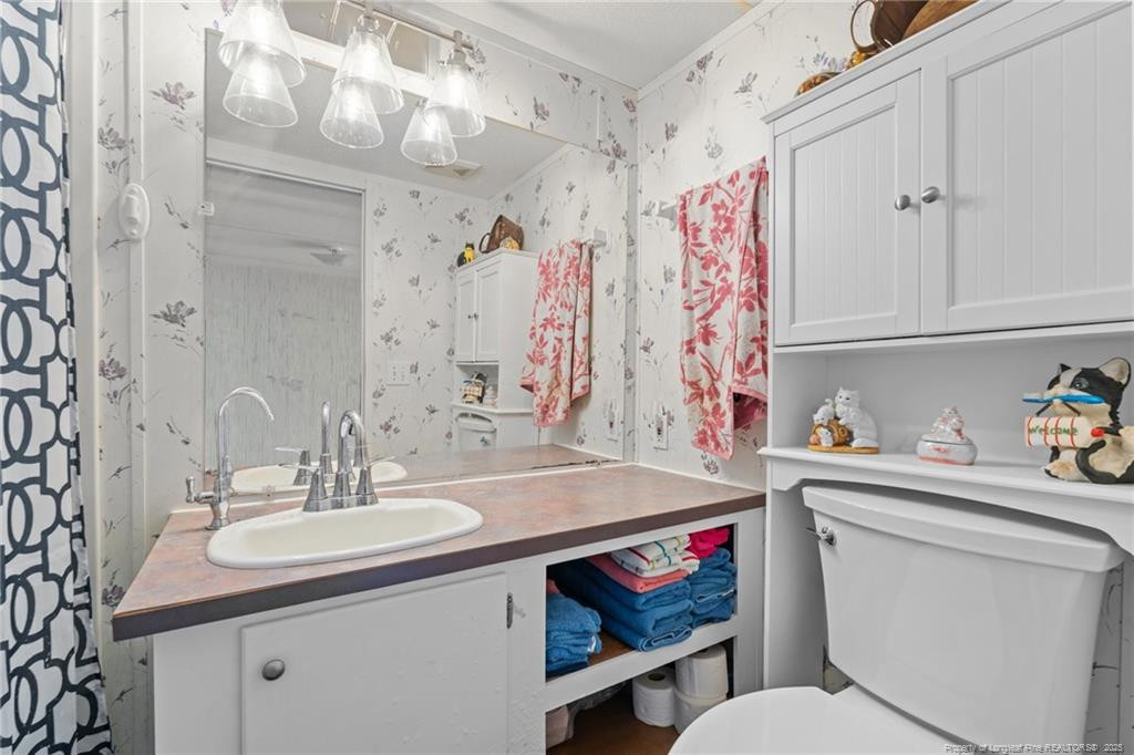 5236-5240 Maxwell Road Stedman, NC 28391 - Photo 5 of 50 a bathroom with a sink vanity granite and toilet