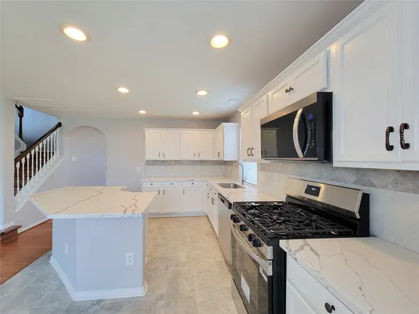 a kitchen with a stove and a sink