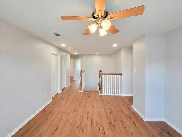 a view of a room with wooden floor