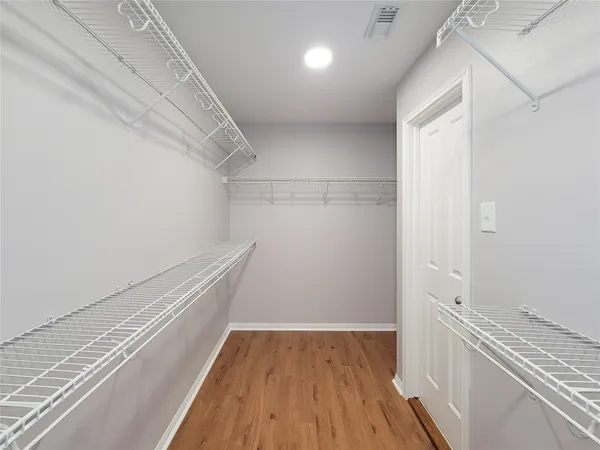 a view of hallway with wooden floor