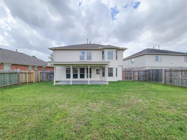 a view of a house with a backyard