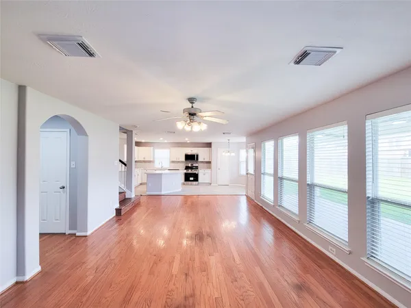 a view of a kitchen with wooden floor and a kitchen
