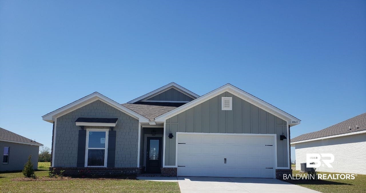 8869 Chabo Circle Foley, AL 36535 - Photo 1 of 33 View of front of house with concrete driveway, an attached garage, and cooling unit