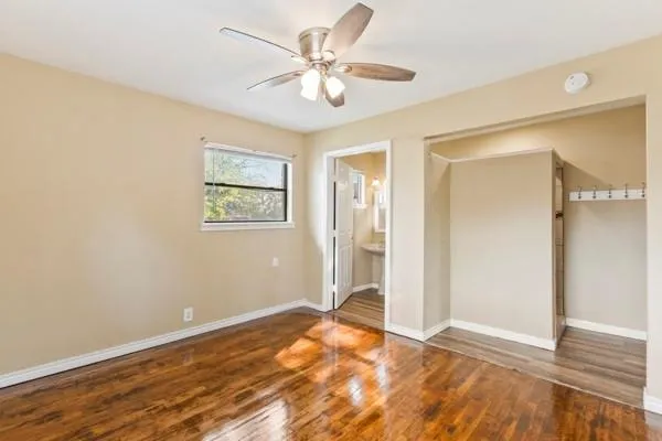 a view of an empty room with wooden floor