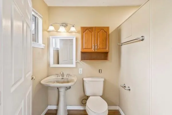 a bathroom with a sink mirror vanity and toilet