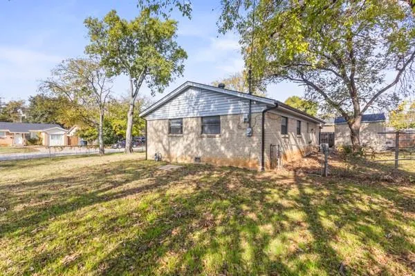 a view of a house with a tree in the background