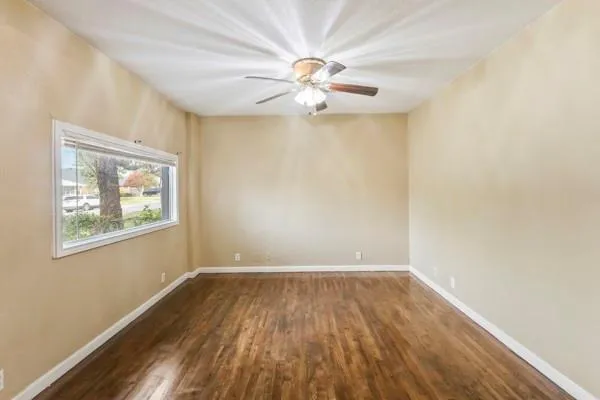 wooden floor in an empty room with a window