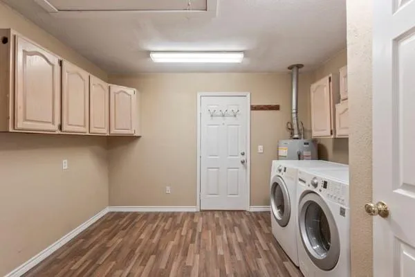 a view of a storage and utility room with washer and dryer